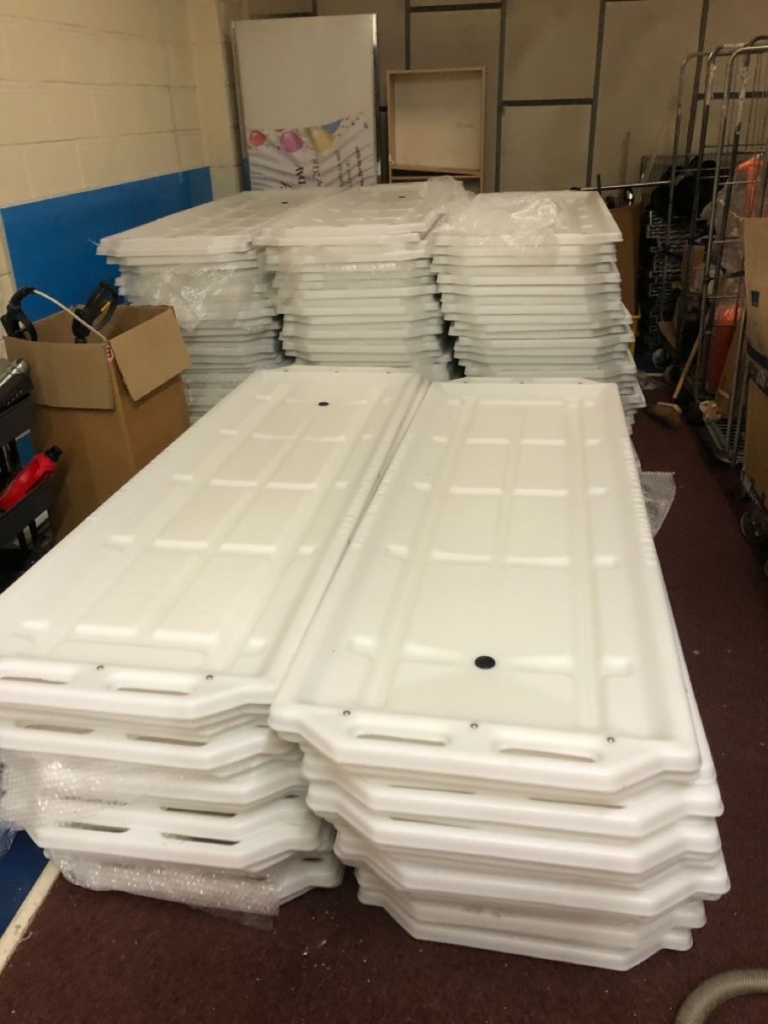 Thermoformed white funeral trays stacked for shipping